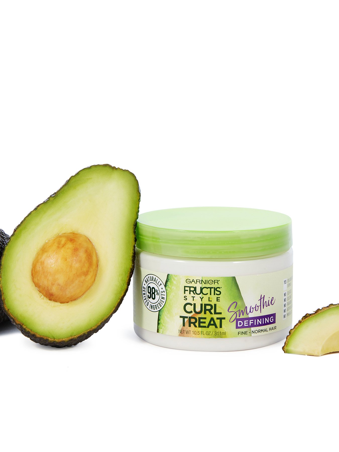 Curl Treat Smoothie Defining Leave-in Styler for Soft Curls next to avocado halves.